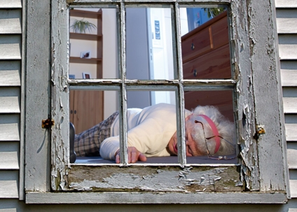 old woman behind lying behind window